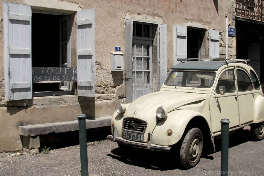Citroën car parked in front of old French home.