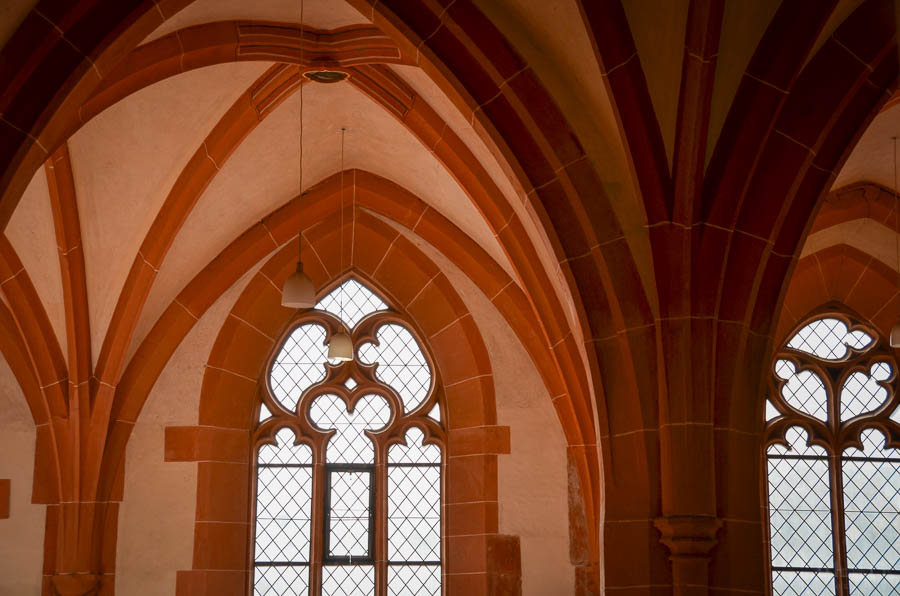 Detail of the interior of the Heiliggeistkirche, including a vaulted ceiling and ornate windows.