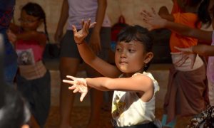 A child dances at a dance studio in Bali.