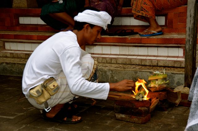 Father lights flame in Balinese Ceremony