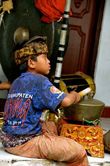 Boy playing Balinese Instrument at Ceremony