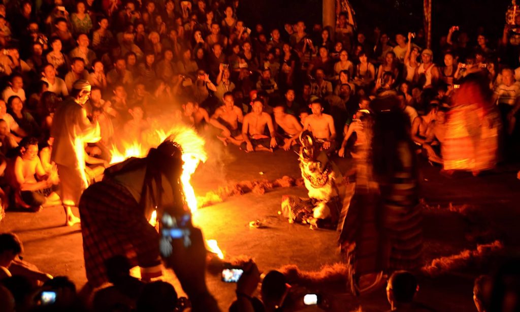 Spectators watch the kecak fire dance at Bali's Uluwatu Temple.
