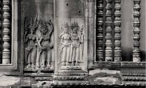 Two pairs of devatas (goddesses) are shown carved into Angkor Wat in Cambodia.