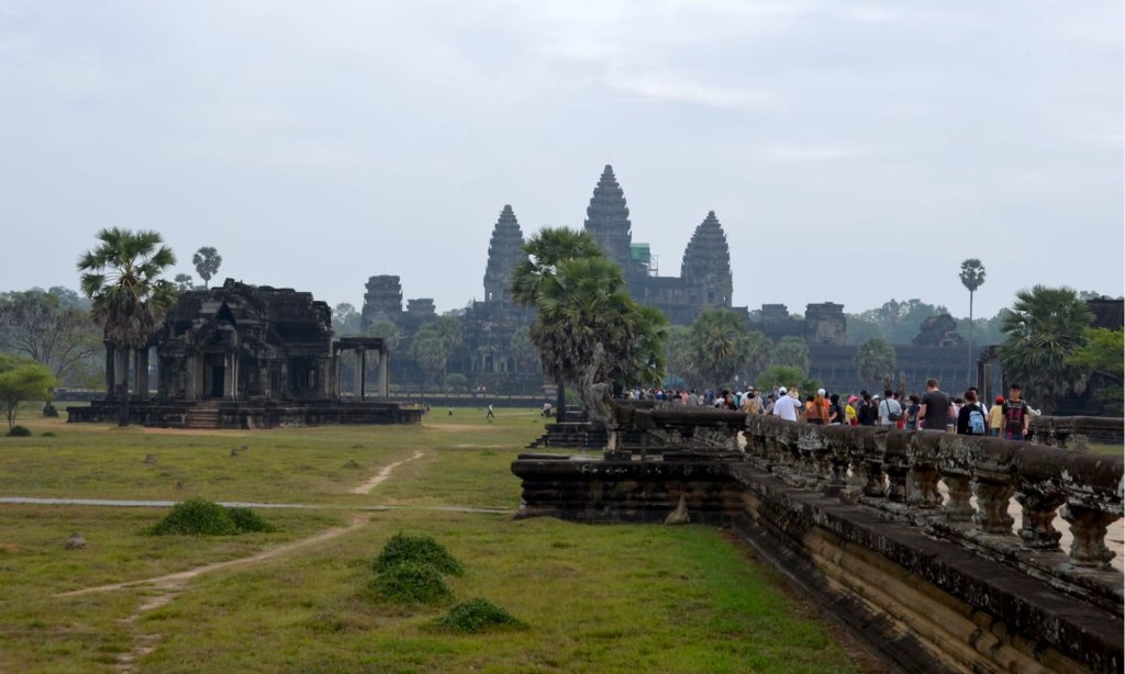 Tourists walk toward Angkor Wat in Cambodia.