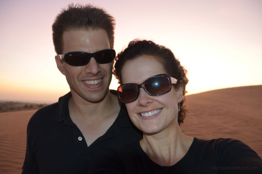 A couple poses at Mui Ne's Red Sand Dunes in Vietnam.