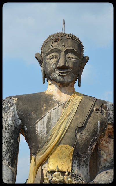 A close-up of the damaged Buddha statue at the Wat Phia Wat temple in Laos.