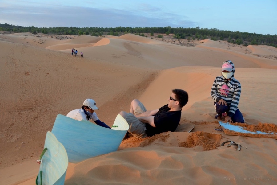 A man sandboards on Mui Ne's Red Dunes.