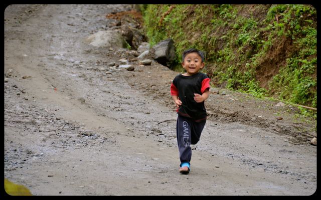 Child running on road from Banaue to Batad