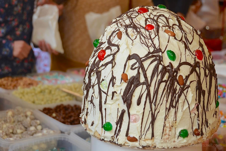 A Maltese cake called prinjolata, traditionally made around Carnival celebrations, sits at a candy stall.