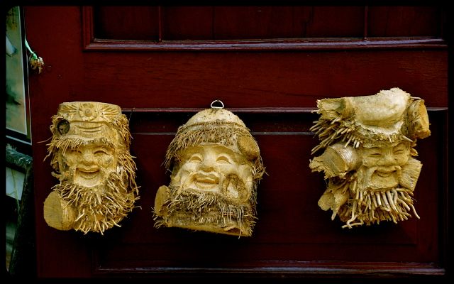 Faced carved out of wood in Hoi An Vietnam Faced carved out of wood in Hoi An Vietnam