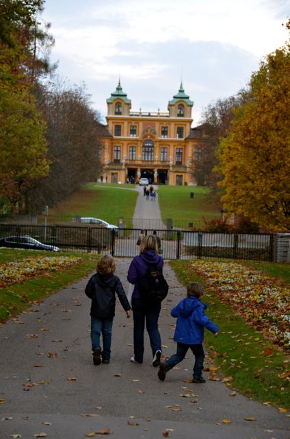 A family walks the grounds of the Ludwigsburg  Palace during its yearly Pumpkin Fest in Germany.
