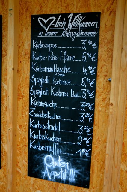 The chalkboard menu at the Ludwigsburg Pumpkin Fest displays food items in German. There's everything from pumpkin soup and pumpkin strudel to pumpkin spaghetti. Prices in Euro are also included.
