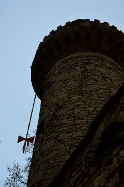 A braid-like rope with a ribbon dangles from a stone tower at the Ludwigsburg Pumpkin Fest in Germany.