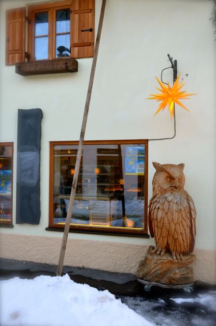 A yellow Christmas star and a large, wooden carved owl in Oberammergau, a town in Germany's Bavaria region.