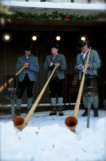 Three Alphornists perform at a winter event in the German town of Oberammergau.