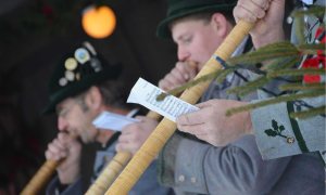 Male alphornists perform in the village of Oberammergau, Germany during a winter festival.