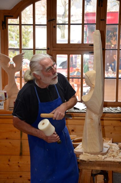A man carves a wooden angel in Oberammergau, Germany.