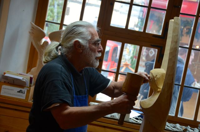 man carving angel figure in oberammergau