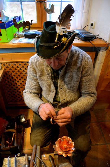 A coppersmith makes a copper bracelet in Oberammergau, Germany.