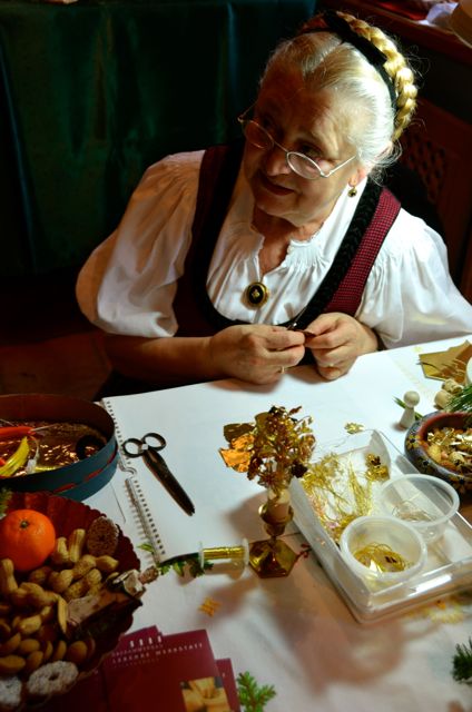 A woman demonstrates gold embroidery techniques in Oberammergau, Germany.