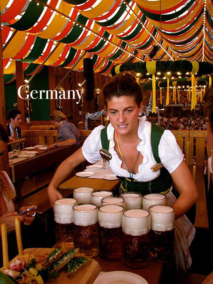 A waitress in a fest tent at Oktoberfest-carries 10 liters of beer mugs in Munich, Germany.