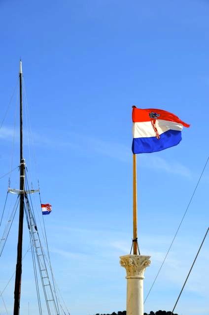 Two Croatian flags blow in the breeze near Trogir, Croatia.