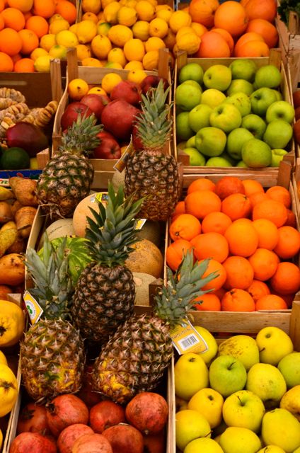 Pineapples, apples, oranges, and pomegranates at Kotor's fresh market.