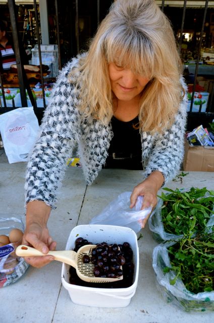 A vendor sells olives at Kotor's fresh market.