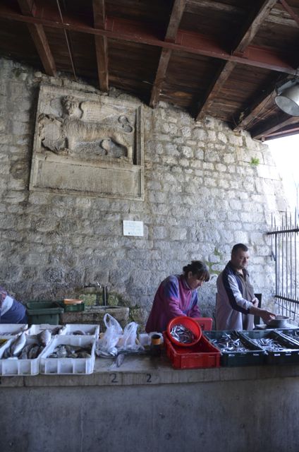 Vendors sell fish inside Kotor's fresh market.