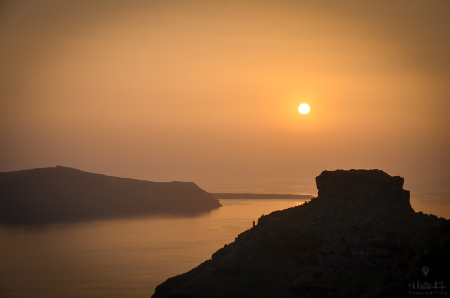 The sun sets over Skaros Rock, on the Greek island of Santorini.