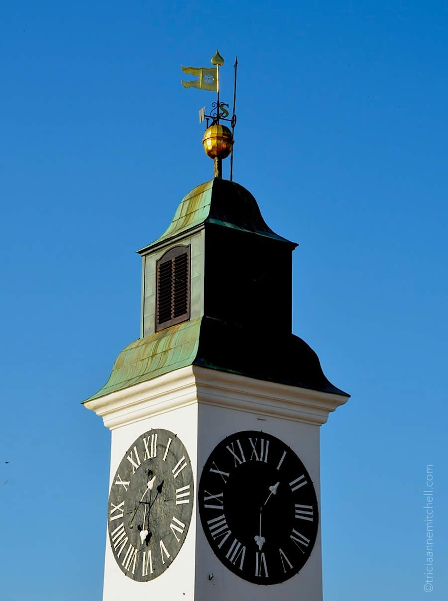 A close-up of the Petrovaradin Clock Tower in Novi Sad, Serbia. It's known for having swapped hour and minute hands on its clockface.