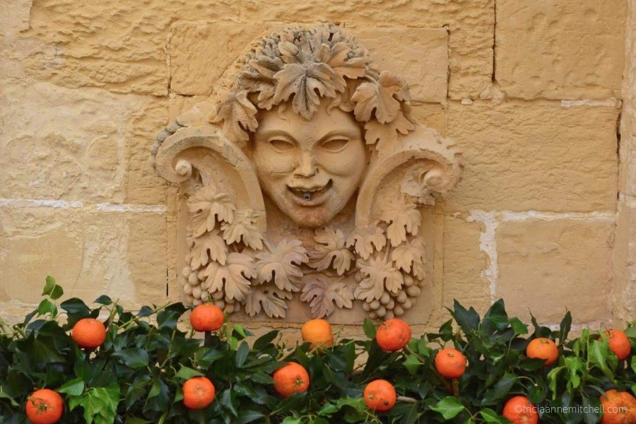 Oranges and greenery decorate a limestone fountain at the Citrus Festival at the San Anton Palace in Malta.