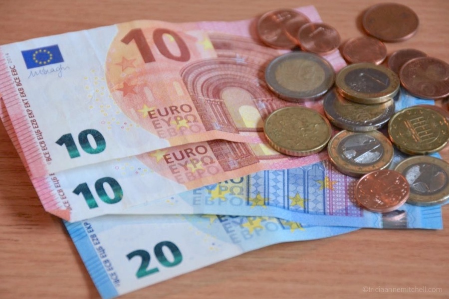Euro currency is pictured: There are two 10-euro banknotes, as well as a variety of euro coins and cents.