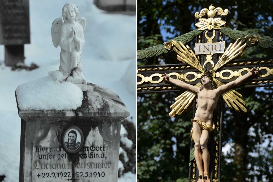 Two different headstones from the Oberammergau Cemetery are pictured. One features a white angel on a grey headstone. The other grave marker features Jesus on a crucifix.