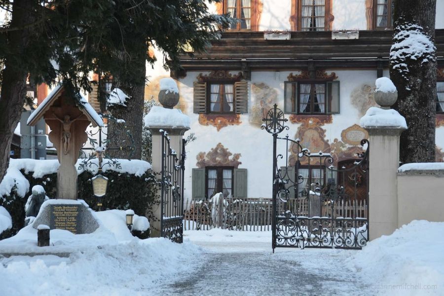 The gated entrance to Oberammergau's cemetery is covered in snow.