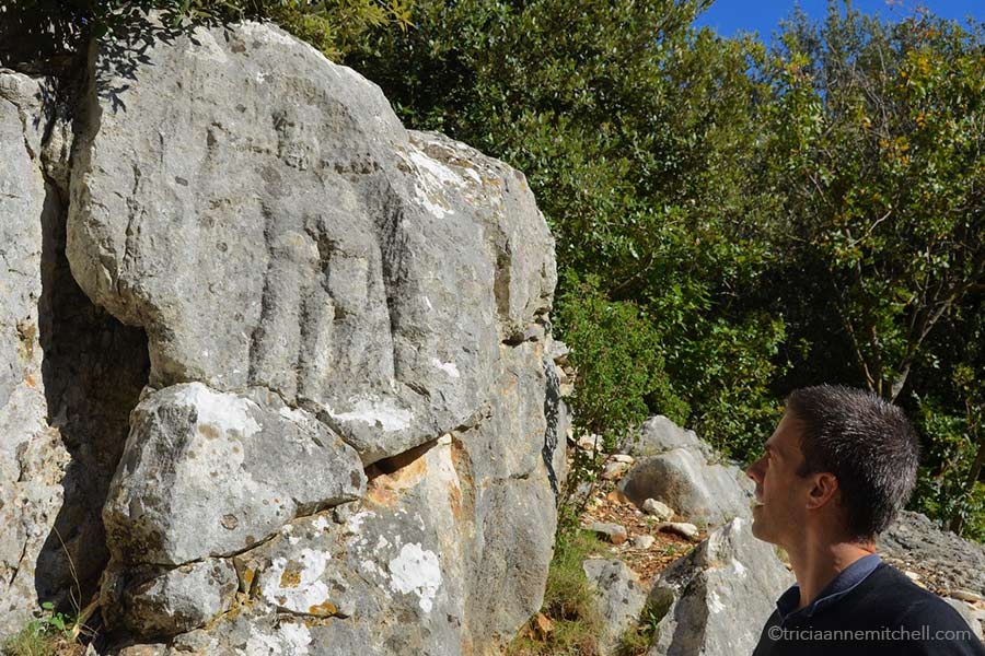 A man looks at the weathered relief depicting Hercules, in an ancient Roman quarry on the Croatian island of Brac.