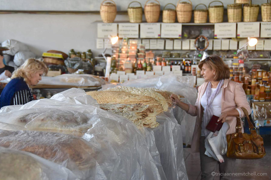 The lavash section of Yerevan's GUM market consists of tables of lavash covered with clear plastic tarps.