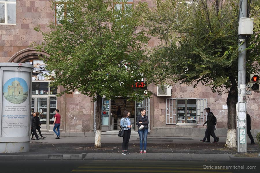 Women stand at a crosswalk in Yerevan, Armenia.