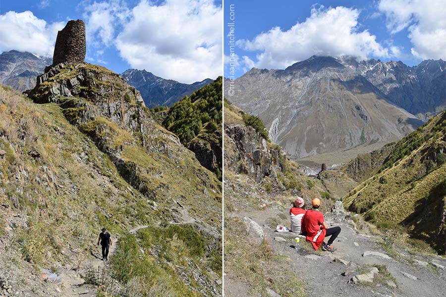 Left: A man dressed in black hikes up a mountain trail in Caucasus Mountains. Right: A couple sitting on a bench pauses to look at the steep mountain slopes that surround them.