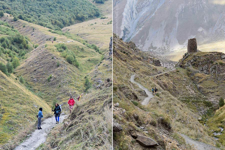 Left: Hikers walk down a path from the Gergeti Trinity Church. You can see a shepherd and his sheep in the background. Right: A pair of hikers is visible in silhouetted form on a curvy dirt path leading past a watchtower in the Caucasus Mountains.