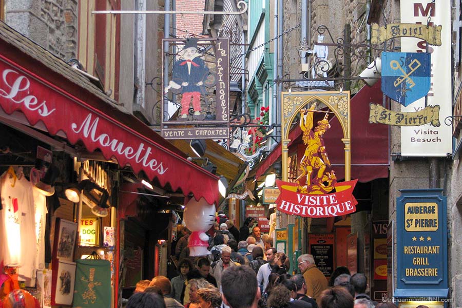 Shops line a street at Mont Saint Michel, France.
