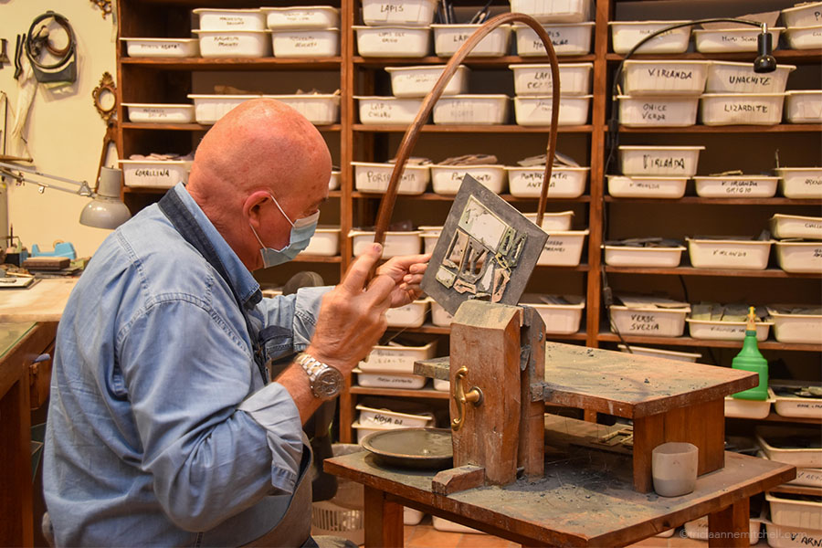 Using a wooden bow saw, Florence artisan Renzo Scarpelli cuts stone with an iron wire.