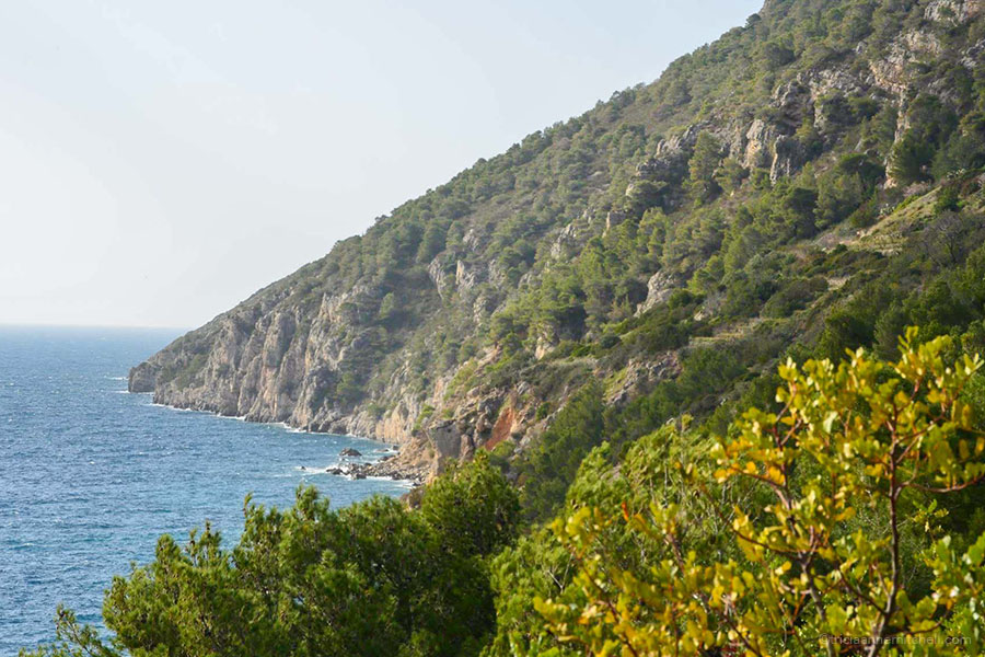 The slopes of a green and rocky mountain meeting the sea in Croatia