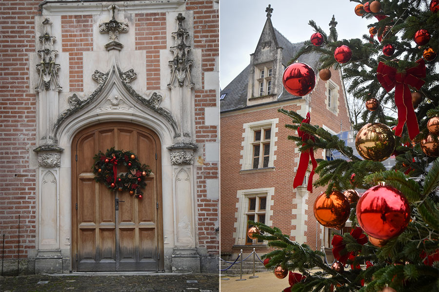 The Clos Lucé Chateau in Amboise, France is decorated for the holidays. In the photo on the left, Christmas wreaths hang on the building's main entryway. In the photo on the right, the brick building is seen in the background, with a Christmas tree in the foreground.