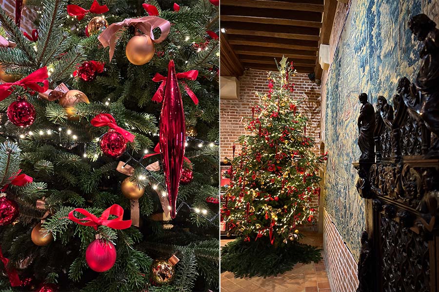 The interior of Clos Lucé in Amboise, France is seen decorated for Christmas with a Christmas tree decorated with red and gold ornaments, and white twinkling lights.