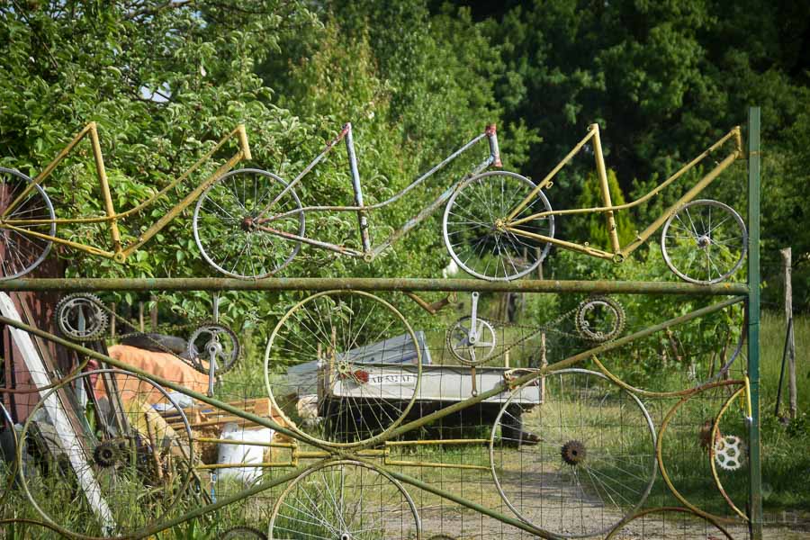 The metal frames of old bicycles adorn gates on the outskirts of Cinq Mars la Pile, France.