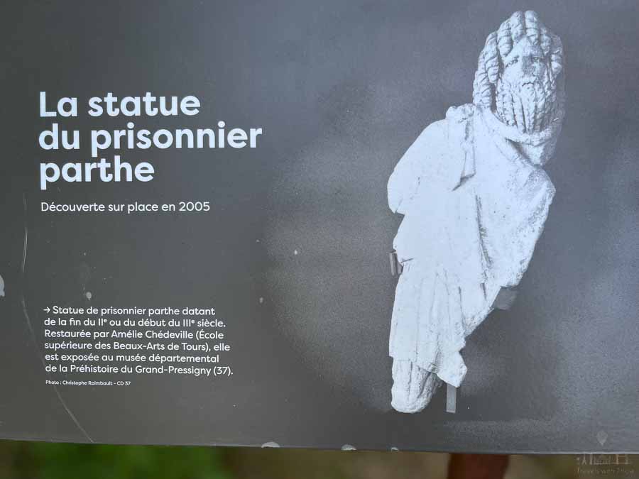 In this snapshot of an informational sign at the Pile de Cinq Mars in France, there's a photograph of a statuette discovered by archaeologists in 2005. The headline, in French, reads: "La statue du prisonnier parthe, découverte sur place en 2005."